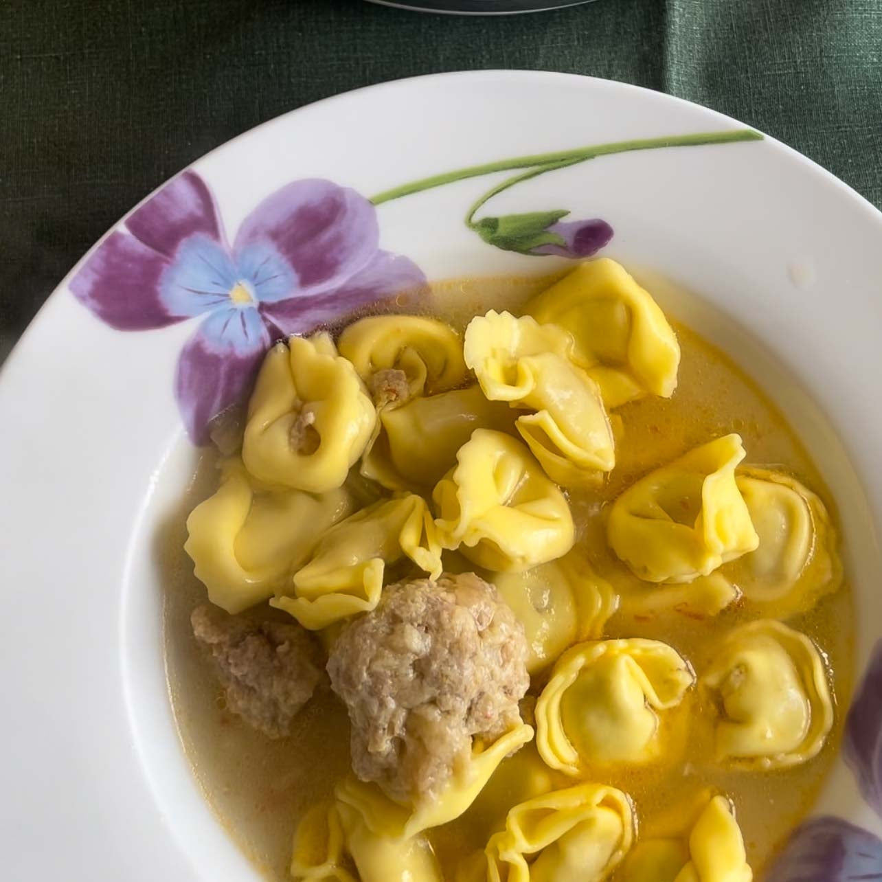 meatball tortellini soup in white bowl