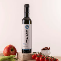 One bottle of EXAU extra virgin olive oil. Label with blue text: Turi